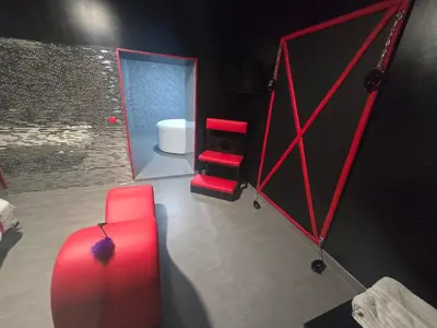 a room with red furniture and a bathroom with a toilet at Parque erotico in Jerez de la Frontera