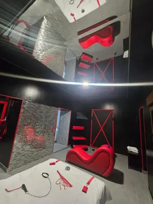a room with a bed and red chairs in it at Parque erotico in Jerez de la Frontera