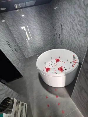 a bathroom with a bath tub with red hearts on the floor at Parque erotico in Jerez de la Frontera