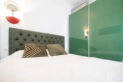 a bedroom with a bed with a pillow on it at Estudio Las Lavanderas de Cádiz in Cádiz