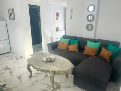 a living room with a couch and a coffee table at Dante Suite in Jerez de la Frontera
