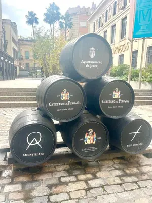 a pile of black barrels sitting on a street at Dante Suite in Jerez de la Frontera