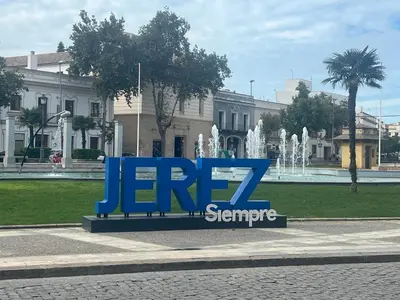 a large blue sign in front of a fountain at Dante Suite in Jerez de la Frontera