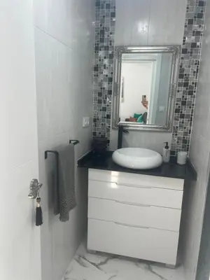 a white bathroom with a sink and a mirror at Dante Suite in Jerez de la Frontera