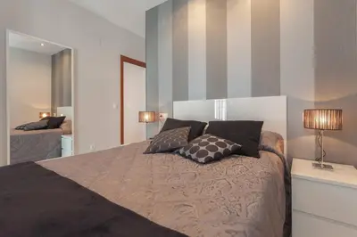 a bedroom with a bed with two pillows on it at Apartamento Castillo San Marcos in El Puerto de Santa María