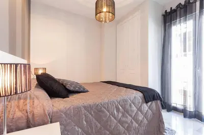 a bedroom with a bed with two pillows on it at Apartamento Castillo San Marcos in El Puerto de Santa María