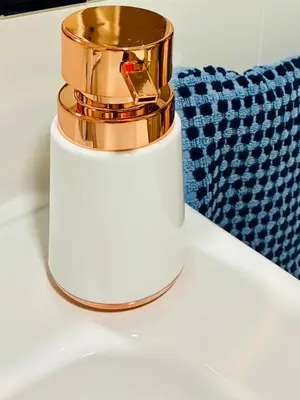 a gold and white soap dispenser sitting on a counter at Apartamento Castillo San Marcos in El Puerto de Santa María