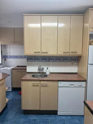 a kitchen with a sink and white appliances at Apartamento Clavel in Chipiona