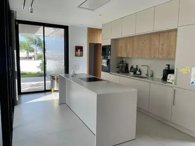 a kitchen with white cabinets and a white counter top at Hostidy Villa Horacia Resort in Sanlúcar de Barrameda