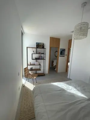 a bedroom with a bed and a chair in a room at Hostidy Villa Horacia Resort in Sanlúcar de Barrameda