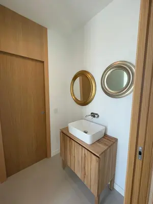 a bathroom with a sink and two mirrors on the wall at Hostidy Villa Horacia Resort in Sanlúcar de Barrameda