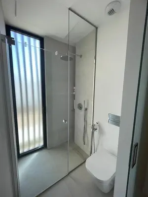 a bathroom with a glass shower with a toilet at Hostidy Villa Horacia Resort in Sanlúcar de Barrameda