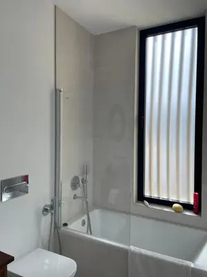 a bathroom with a tub and a toilet and a window at Hostidy Villa Horacia Resort in Sanlúcar de Barrameda