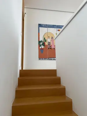 a staircase in a house with a painting on the wall at Hostidy Villa Horacia Resort in Sanlúcar de Barrameda