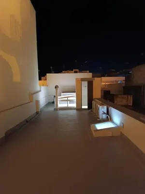 a room with a table and a bench on a roof at San Miguel in San Fernando