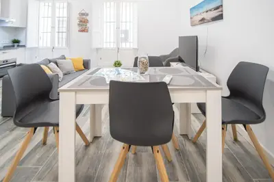 a dining room with a table and chairs at Estudio Viñamar Cádiz in Cádiz