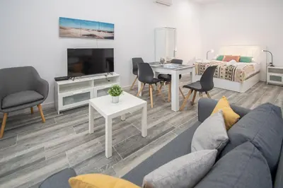 a living room with a couch and a table at Estudio Viñamar Cádiz in Cádiz