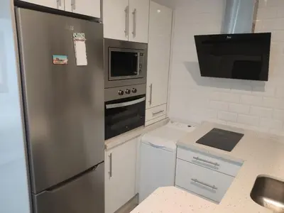a kitchen with a stainless steel refrigerator and a microwave at Apartamento Santa Teresa in Cádiz