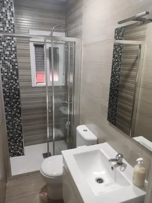 a bathroom with a toilet and a sink and a shower at Apartamento Santa Teresa in Cádiz