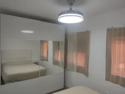 a bedroom with a bed and a glass cabinet at Apartamento Santa Teresa in Cádiz