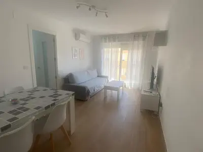 a living room with a couch and a table at Cachucha Apartment in Puerto Real