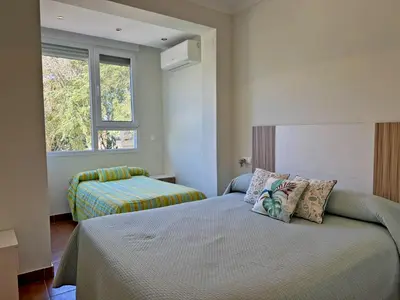 a bedroom with two beds and a window at El Bosque del Duende - Ole Solutions in Arcos de la Frontera