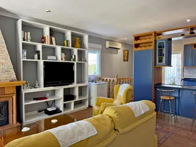 a living room with a couch and a tv at El Bosque del Duende - Ole Solutions in Arcos de la Frontera