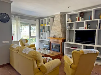 a living room with yellow chairs and a fireplace at El Bosque del Duende - Ole Solutions in Arcos de la Frontera