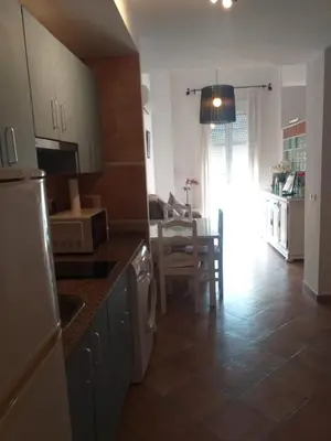 a kitchen with a counter and a dining room at centro Puerto de Santamaria in El Puerto de Santa María