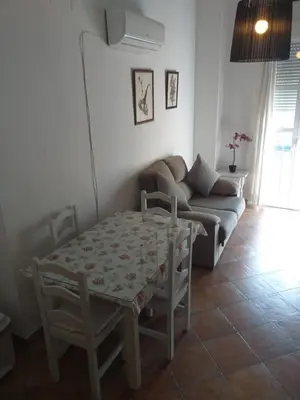 a living room with a table and a couch at centro Puerto de Santamaria in El Puerto de Santa María
