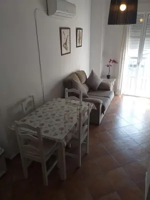 a living room with a table and a couch at centro Puerto de Santamaria in El Puerto de Santa María