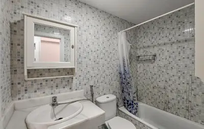 a bathroom with a sink and a toilet and a mirror at Awesome Home In Rota With Wifi in Rota