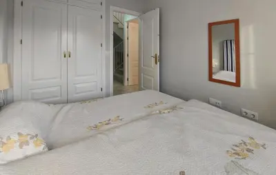 a white bed in a room with a mirror at Awesome Home In Rota With Wifi in Rota