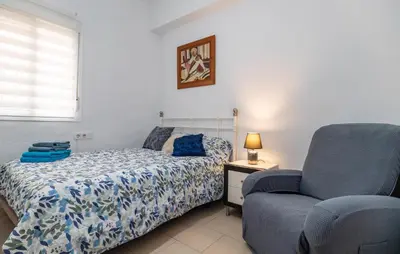a bedroom with a bed and a chair at Casa Chico in Arcos de la Frontera