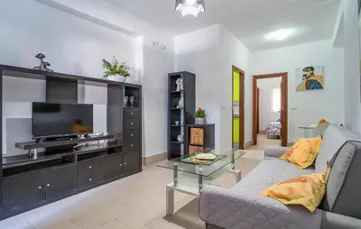 a living room with a couch and a flat screen tv at Casa Chico in Arcos de la Frontera