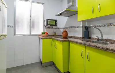 a kitchen with bright green cabinets and a sink at Casa Chico in Arcos de la Frontera