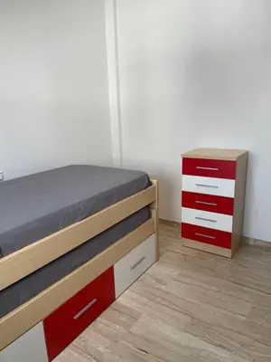 a bedroom with a bed with red and white drawers at JC 7 Chalet in Chiclana de la Frontera