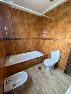 a bathroom with a toilet and a tub and a sink at JC 7 Chalet in Chiclana de la Frontera