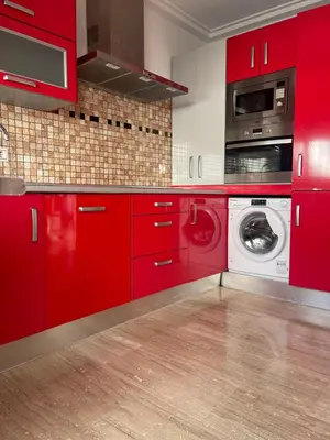 a red kitchen with a washing machine and a washer at JC 7 Chalet in Chiclana de la Frontera