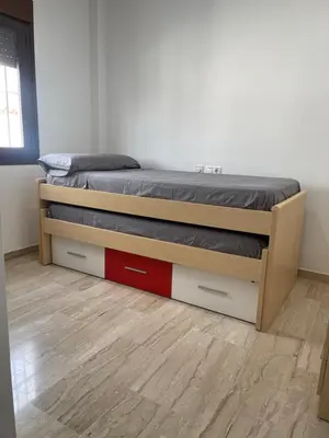 a bedroom with a bed with two drawers at JC 7 Chalet in Chiclana de la Frontera