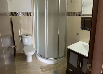 a bathroom with a toilet and a shower and a sink at JC 7 Chalet in Chiclana de la Frontera