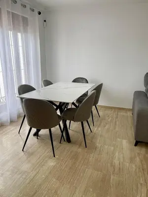 a white table and chairs in a room at JC 7 Chalet in Chiclana de la Frontera