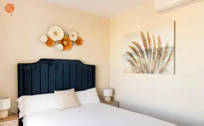 a bedroom with a bed with a black headboard at Penthouse Plaza San Antonio Grupo AC Gestion in Cádiz