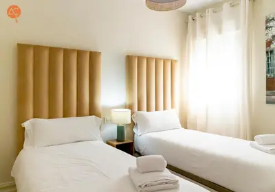 two beds sitting next to each other in a room at Penthouse Plaza San Antonio Grupo AC Gestion in Cádiz
