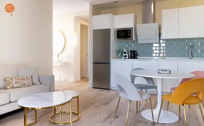a kitchen and living room with a table and chairs at Penthouse Plaza San Antonio Grupo AC Gestion in Cádiz