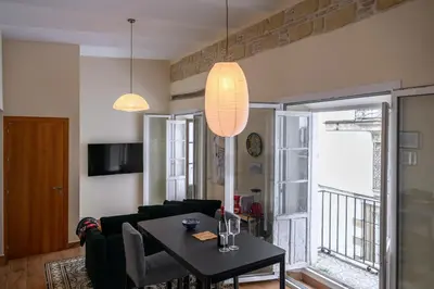 a living room with a table and a couch at Casa Del Encanto Arcos in Arcos de la Frontera