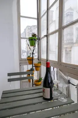 a bottle of wine sitting on a table with glasses at Casa Del Encanto Arcos in Arcos de la Frontera