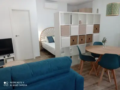 a living room with a blue couch and a table at Apartamento Mar III in San Fernando