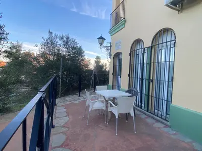 a patio with a table and chairs on a balcony at Estudio playa la muralla in El Puerto de Santa María