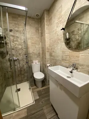 a bathroom with a toilet and a sink and a shower at Estudio playa la muralla in El Puerto de Santa María